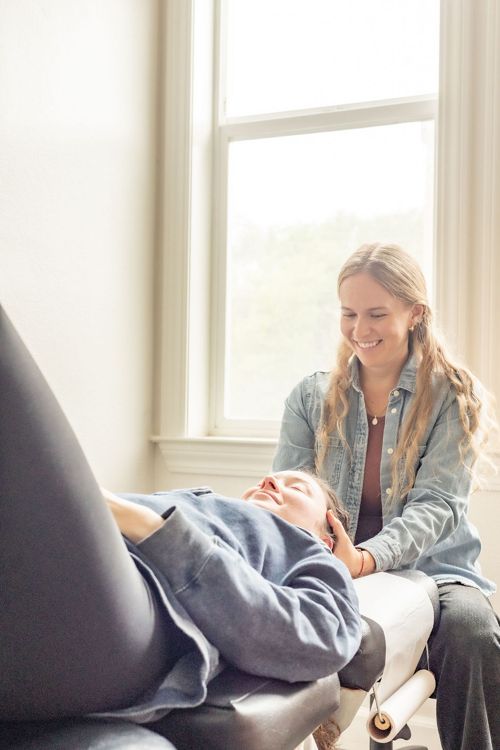 Dr. Laura Barnum treating a patient in a bright treatment room
